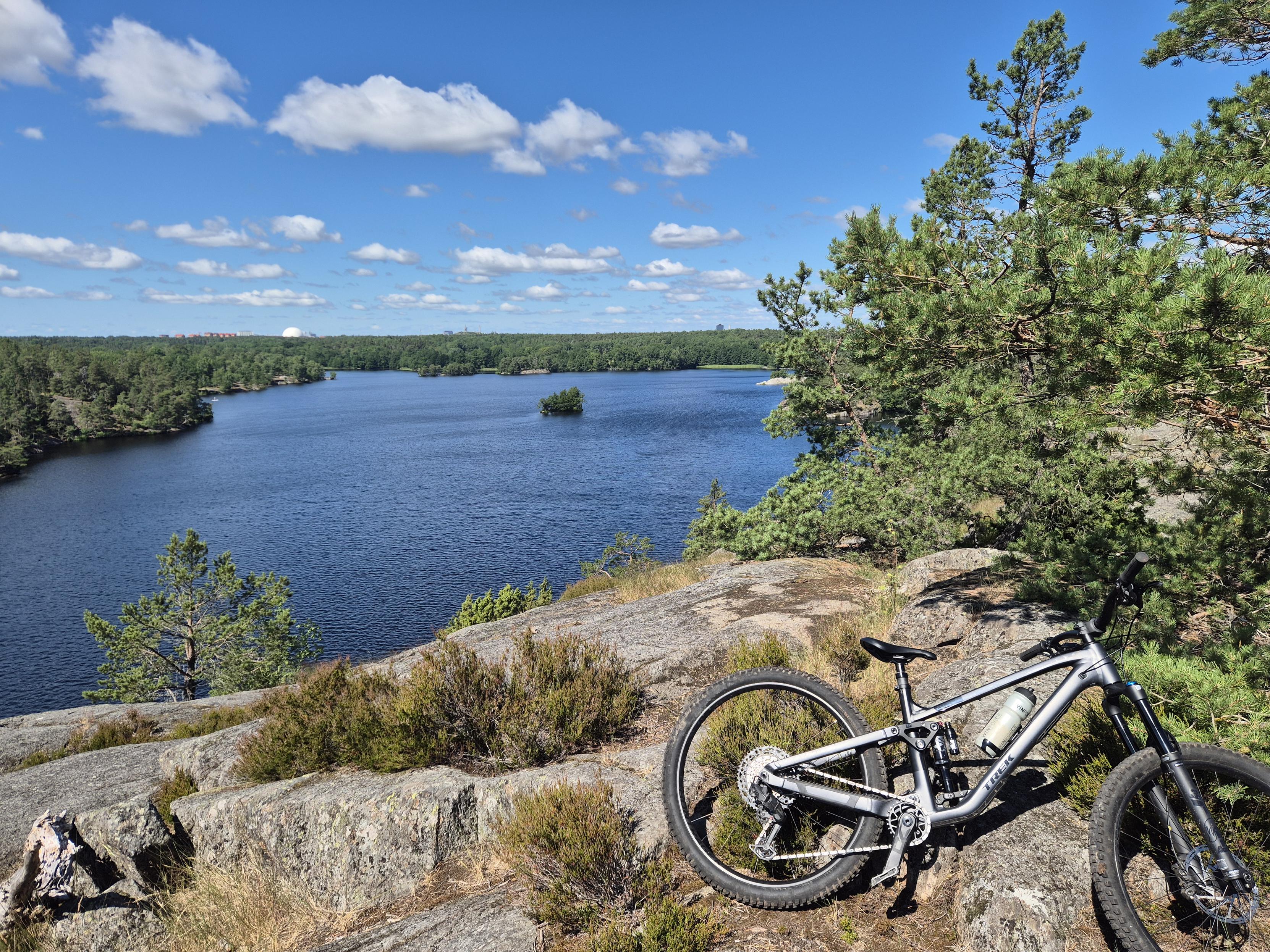 Photo of a lake taken from a height with a bikein the foreground.